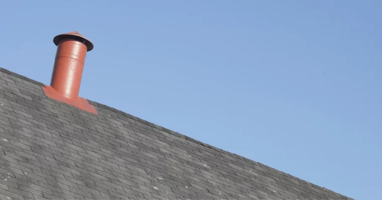 dark roof shingles and red ventilation pipe