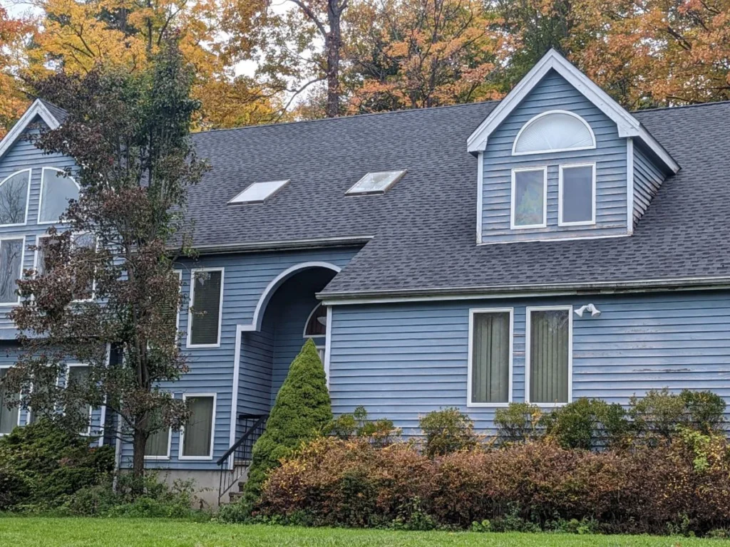 new gaf timberline roof on house with light blue siding