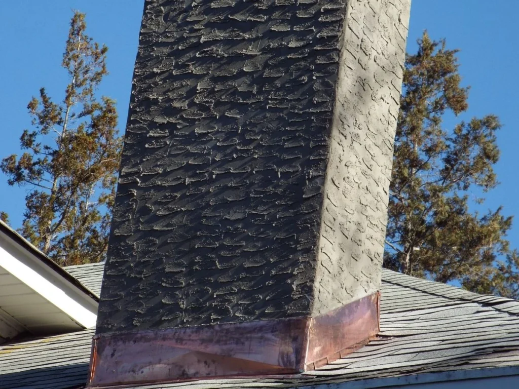 masonry chimney with copper flashing after repair