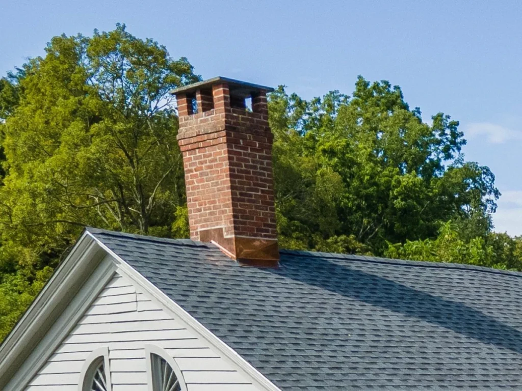 beautiful new copper chimney flashing with new asphalt shingle roof