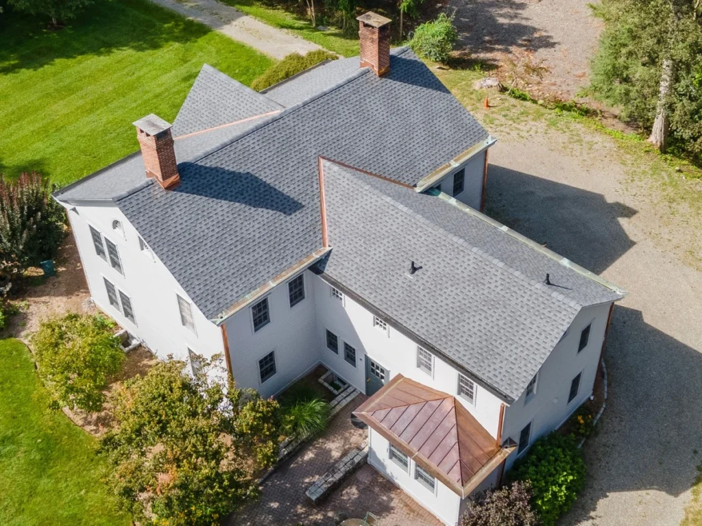 drone photograph of brand new roof replacement with copper flashing