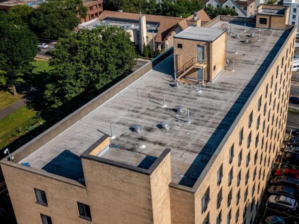 Drone photo of New Rochelle apartment building before flat roof replacement