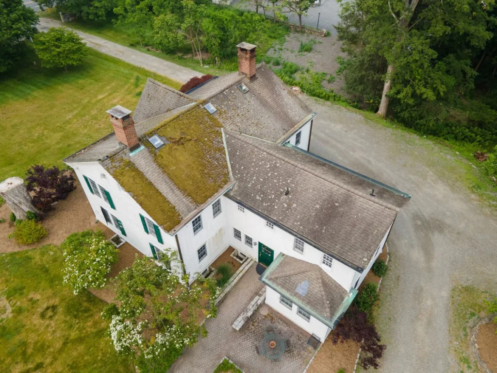 rear aerial view of after gaf timberline hdz roof replacement with moss and old shingles