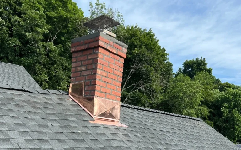 chimney repair on asphalt shingle roof with brick chimney and copper flashing