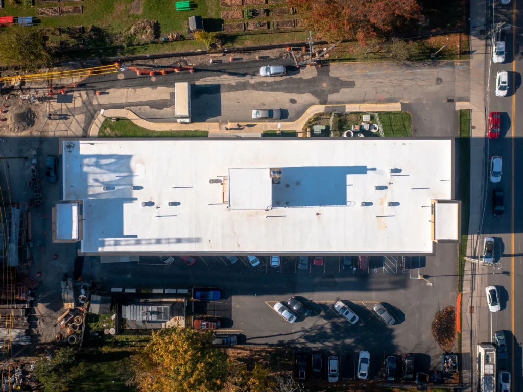 over top aerial view of a white TPO johns manville roof on residential building in new rochelle, NY