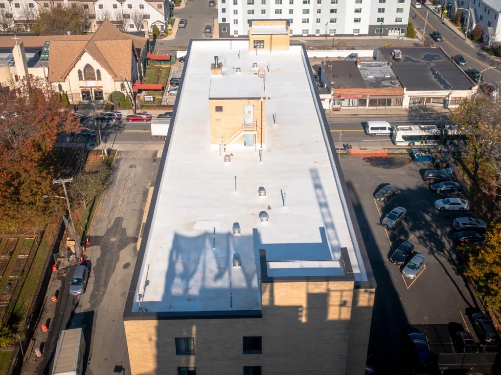 front aerial view of a white TPO johns manville roof on residential building in new rochelle, NY