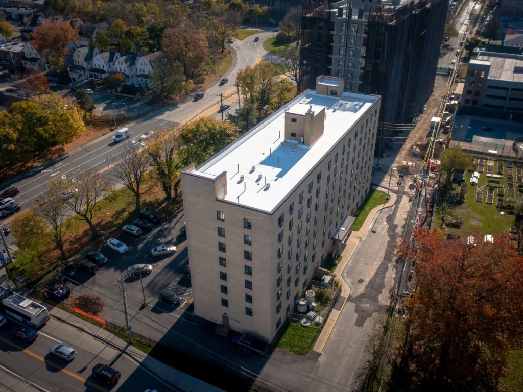 side aerial view of a white TPO johns manville roof on residential building in new rochelle, NY