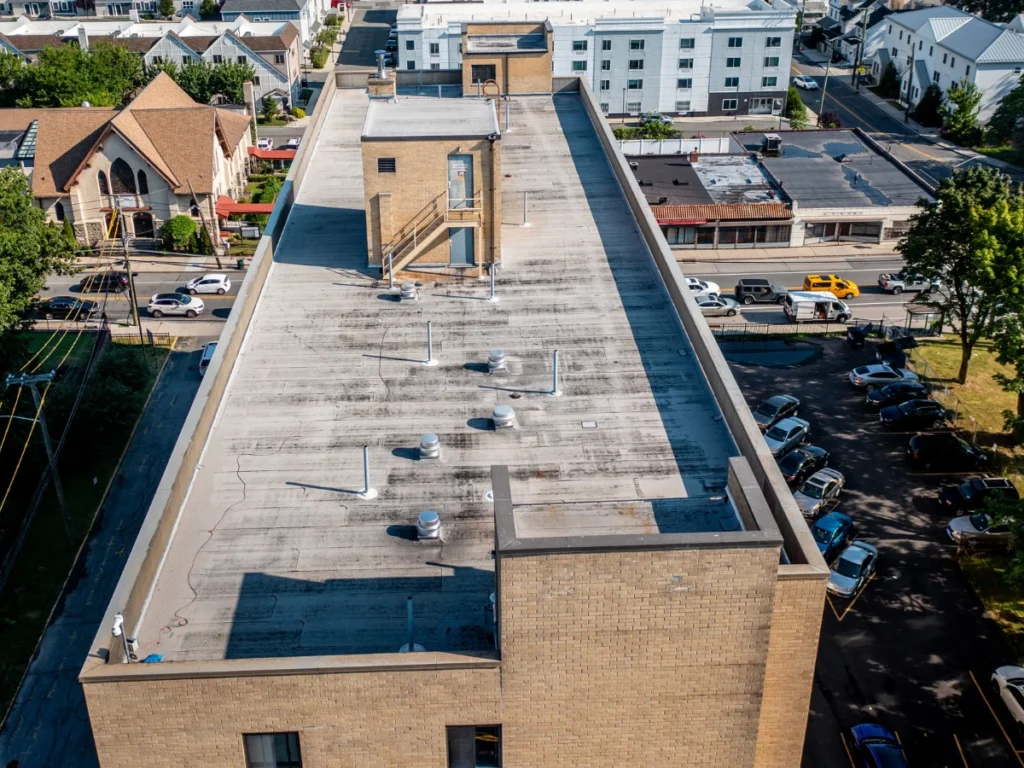 aerial view of a discolored flat roof on residential building in new rochelle, NY