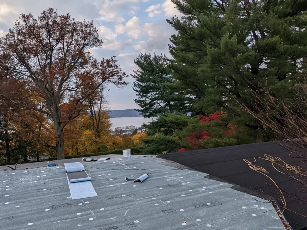 roof replacement in progress at hilltop mansion in tarrytown, ny