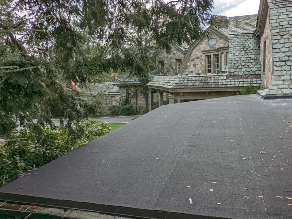 newly installed flat black asphalt roof at hilltop mansion in tarrytown