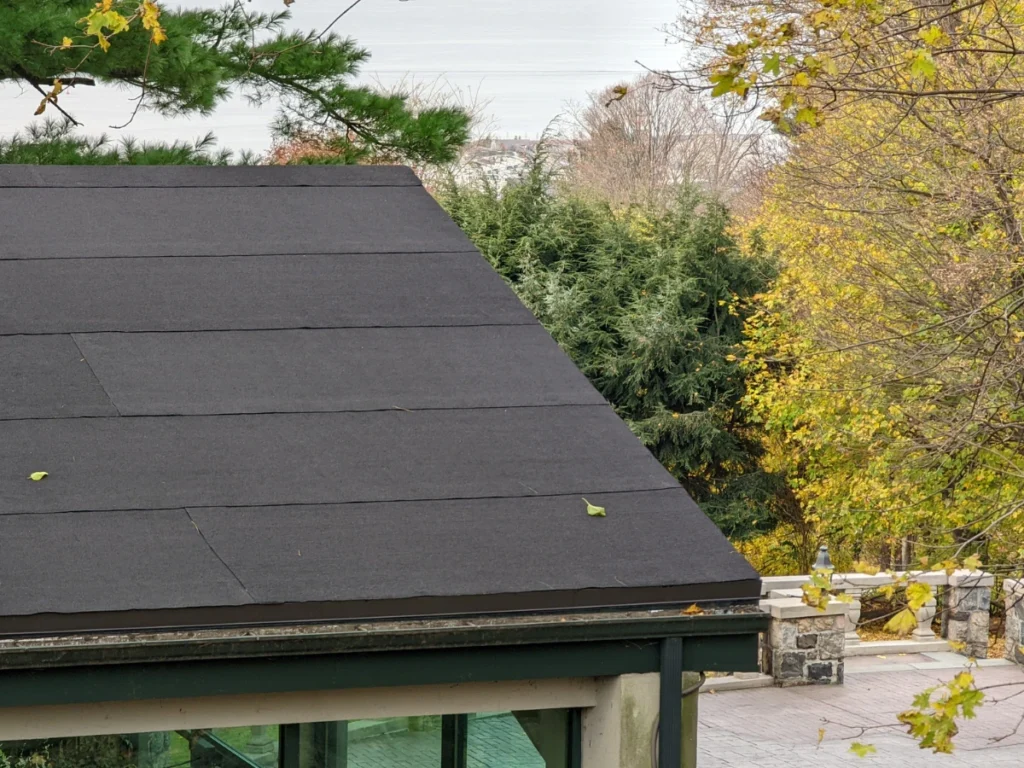 close up of low-slope black asphalt roof overlooking the outdoor reception area at Hilltop Mansion in Tarrytown, NY