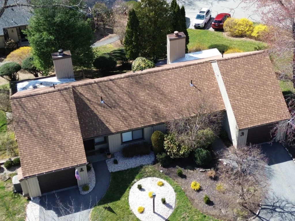 Condo complex with a new brown shingle roof near Katonah, NY, viewed from above.