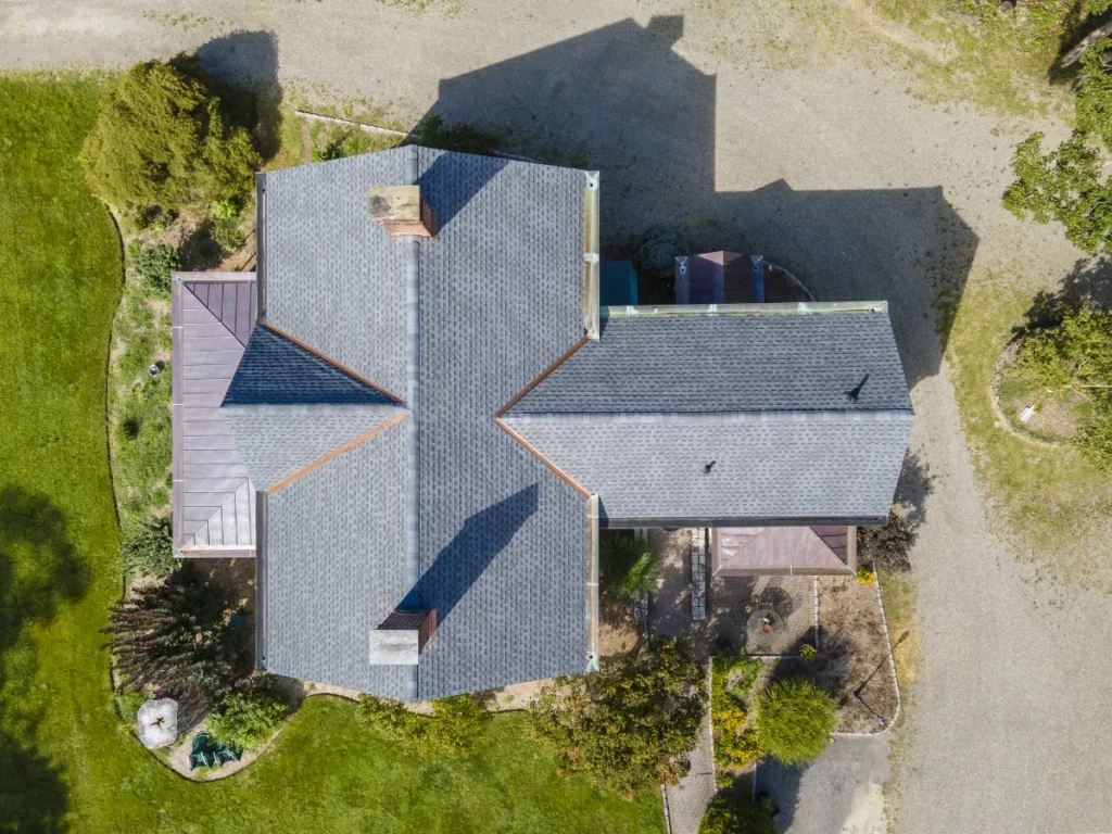 drone photo of the top of a brand new asphalt shingle roof in a light grey color near shrub oak, ny