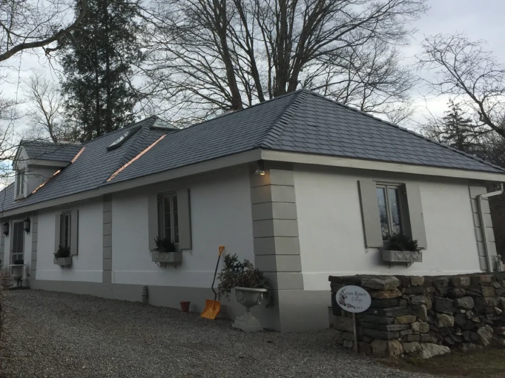 house with brand new synthetic slate roof and copper roof valleys