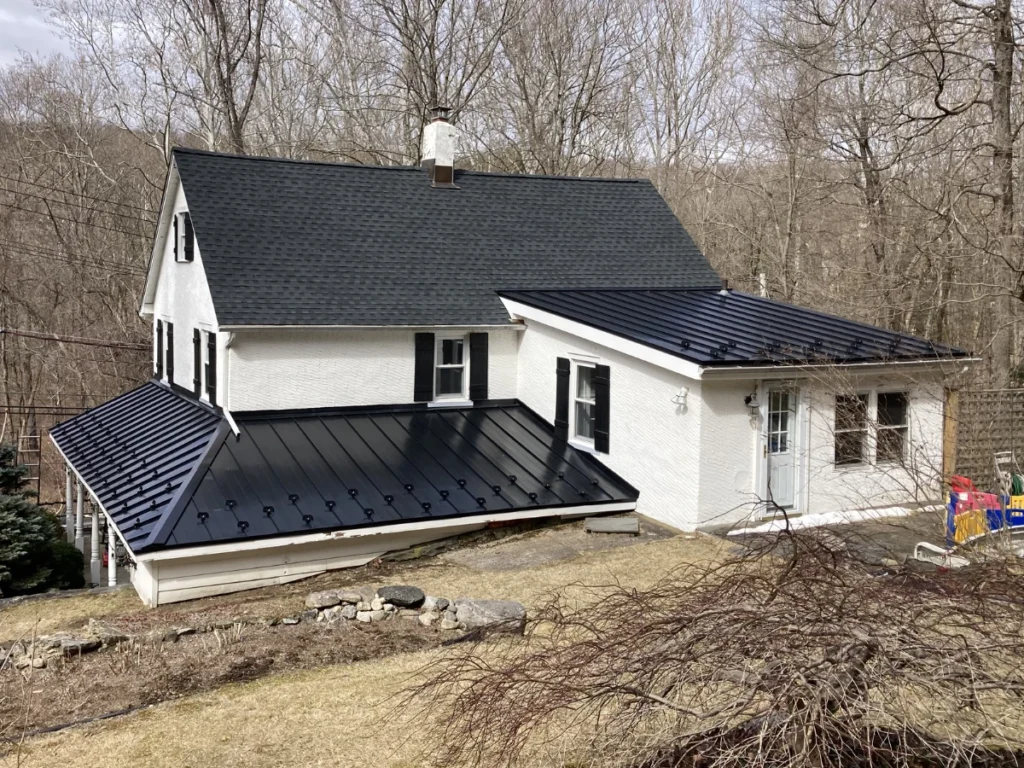 new black shingle roof, with a lower custom metal roof on house with white siding near shrub oak, ny