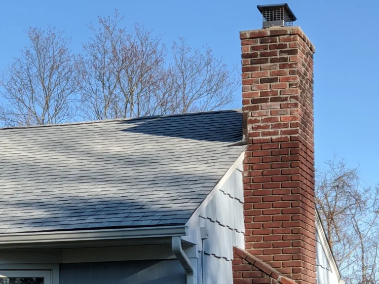 close up of new grey shingle roof and a brick chimney near ossining, ny