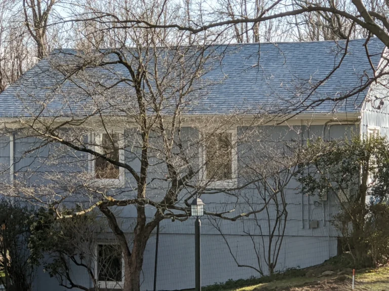 house with blue siding and new light grey shingle roof