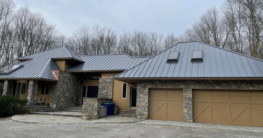metal roof replacement near ardsley ny on single story residential home with stone facad