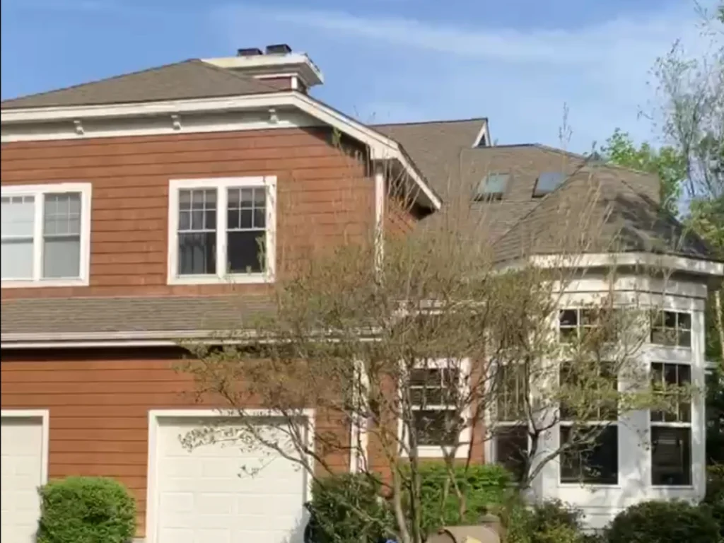 roof replacement on a condo in tarrytown, ny with brown wood shake siding and a weathered wood color shingle roof, feautring multiple skylights