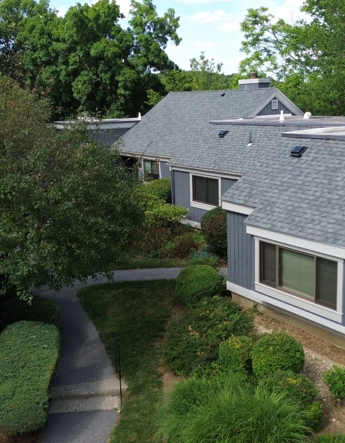 shingle roof replacement on townhome with grey siding near brewster ny