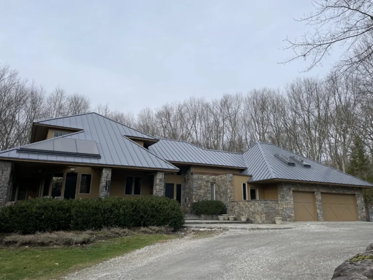 custom fabricated metal roof installed on single story home with stone siding near brewster, ny