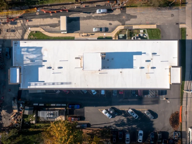 Commercial building near Mamaroneck after a new white flat TPO roof after replacement.